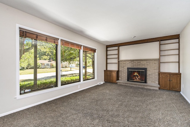 unfurnished living room featuring visible vents, a fireplace, baseboards, and carpet floors