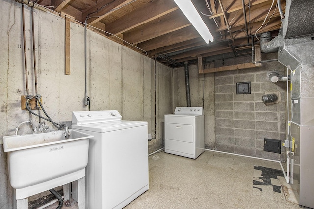 laundry area with a sink, laundry area, and washer and clothes dryer