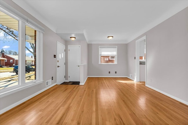 unfurnished living room with visible vents, baseboards, and light wood-style floors