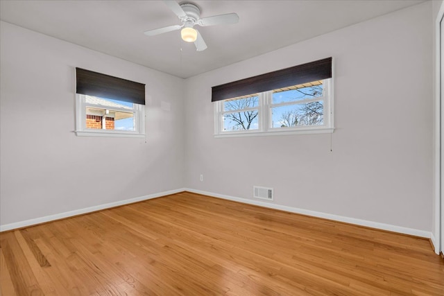 unfurnished room with visible vents, ceiling fan, baseboards, and light wood-style floors