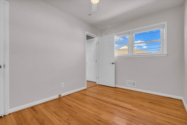 unfurnished bedroom with a ceiling fan, light wood-style flooring, baseboards, and visible vents