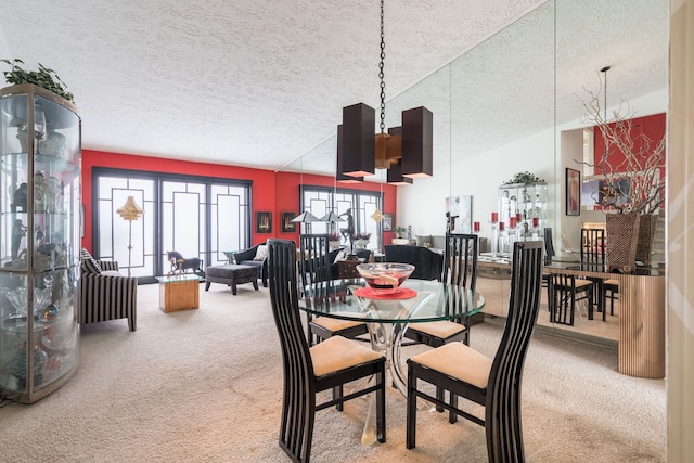 dining area featuring carpet flooring and a textured ceiling