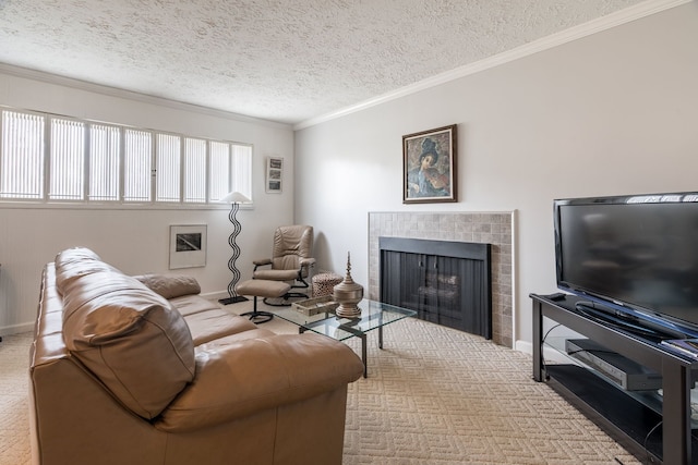 living room featuring crown molding, baseboards, carpet floors, a tile fireplace, and a textured ceiling