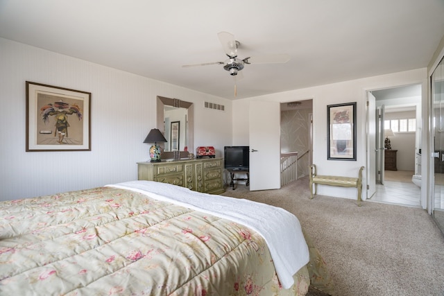 bedroom with visible vents, light colored carpet, and ceiling fan