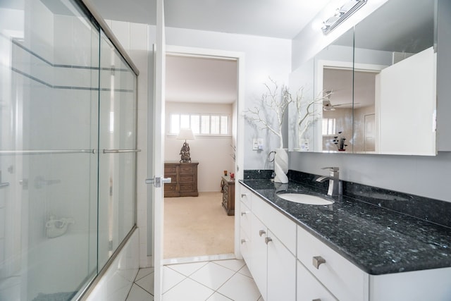 bathroom with tile patterned flooring, vanity, and shower / bath combination with glass door