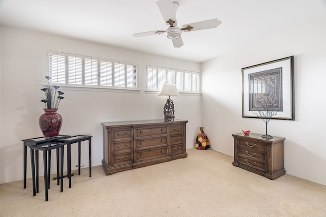 bedroom featuring light colored carpet and ceiling fan