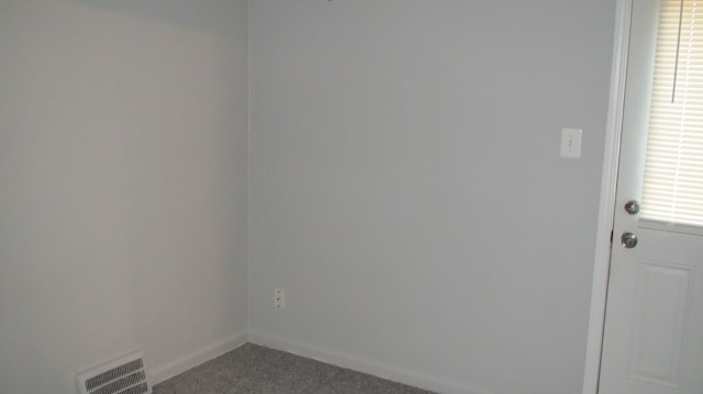 spare room with visible vents, baseboards, and carpet