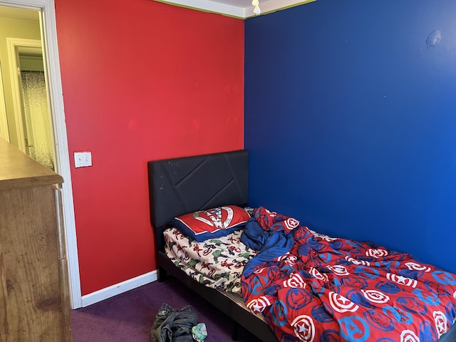 bedroom with baseboards and carpet floors