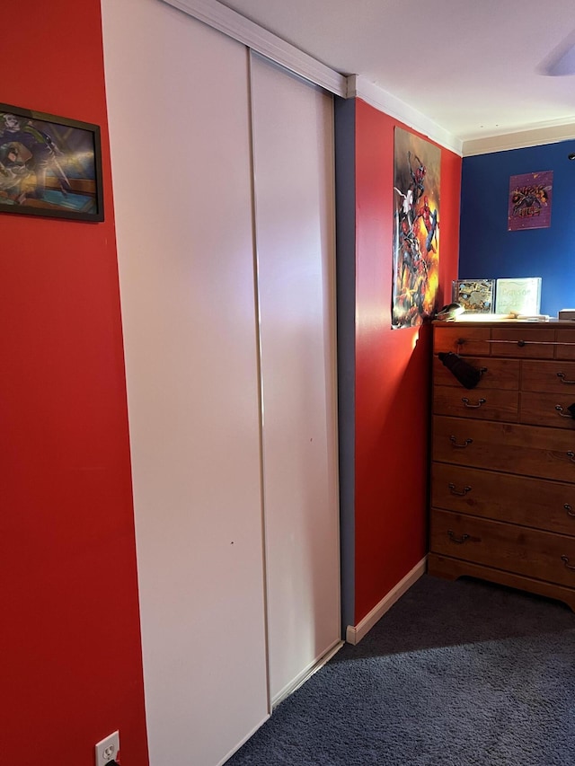 bedroom with carpet, a closet, and baseboards