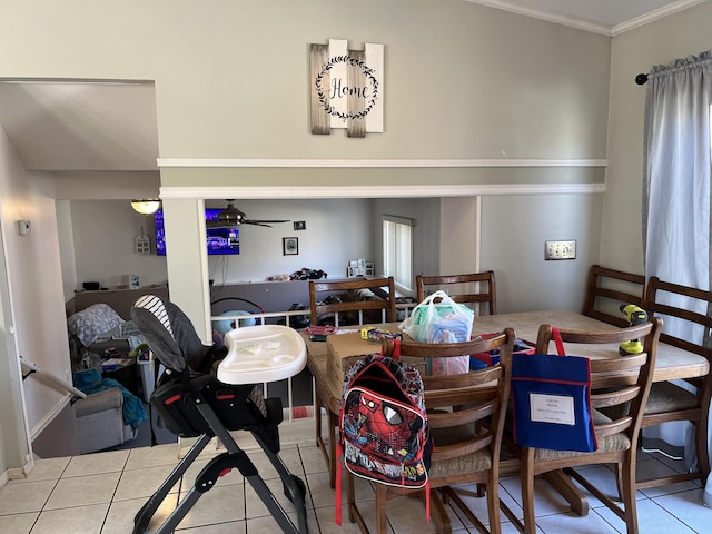 tiled dining area featuring crown molding