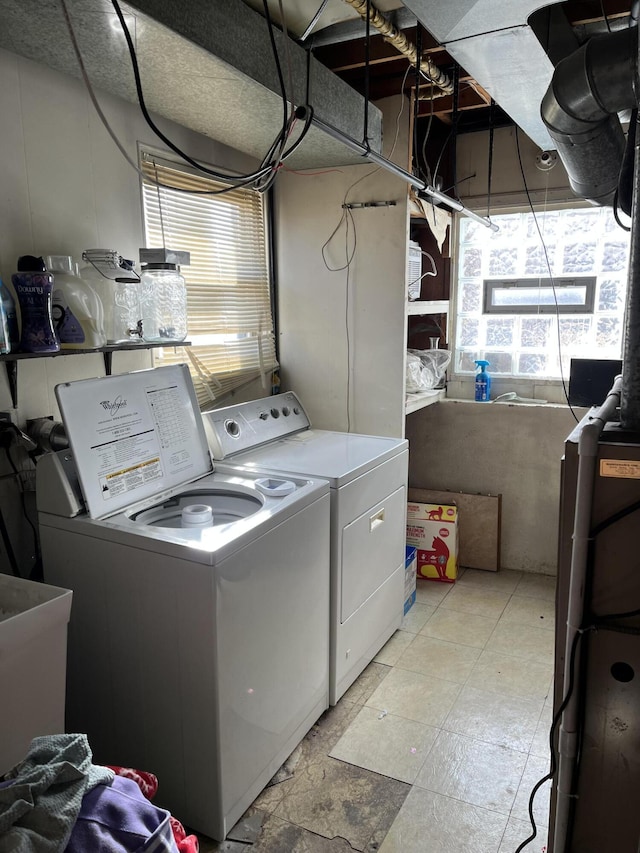 laundry room featuring laundry area, washing machine and dryer, and a sink