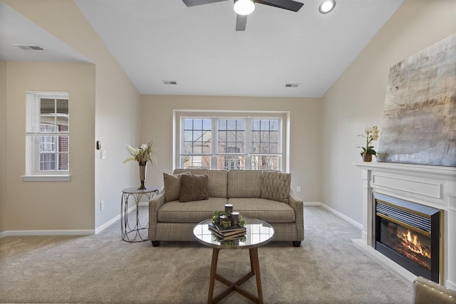 living room with visible vents, carpet, and vaulted ceiling