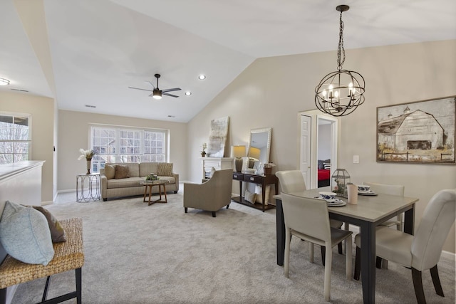 dining room featuring light carpet, plenty of natural light, ceiling fan with notable chandelier, and baseboards