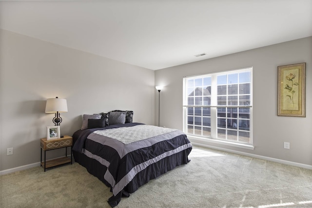 bedroom with carpet flooring, visible vents, and baseboards