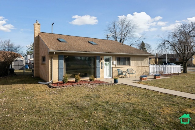 single story home with fence, a chimney, a front lawn, a patio area, and brick siding