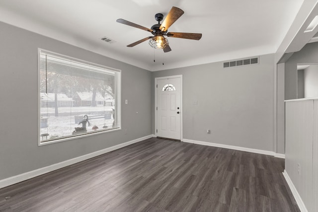 foyer entrance with visible vents, ceiling fan, baseboards, and dark wood-style flooring