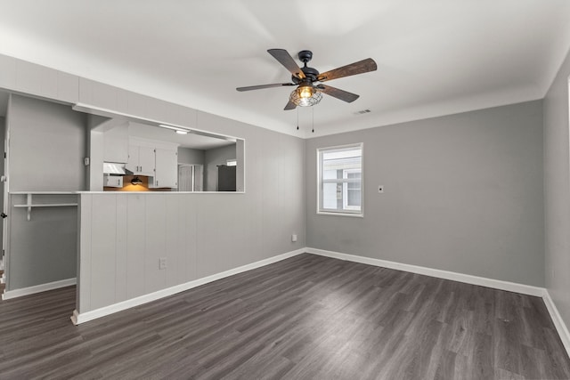 unfurnished living room with visible vents, baseboards, dark wood-style floors, and a ceiling fan