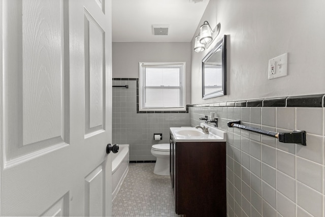 full bathroom with vanity, visible vents, tile patterned flooring, tile walls, and toilet