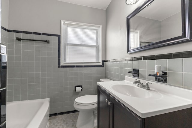 full bath with tile patterned floors, toilet, a bathing tub, tile walls, and vanity