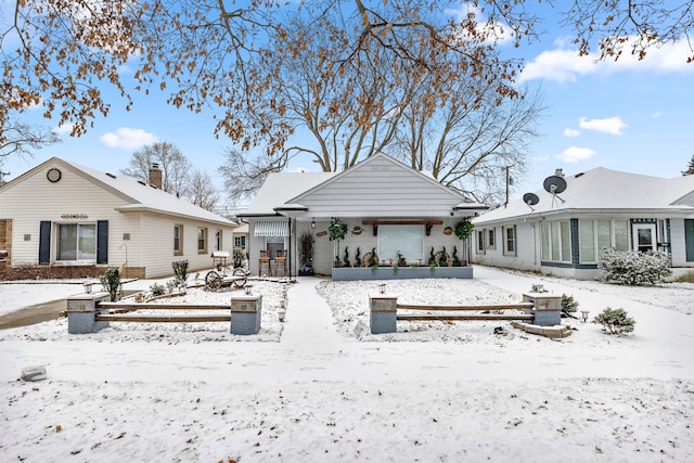 view of snow covered rear of property