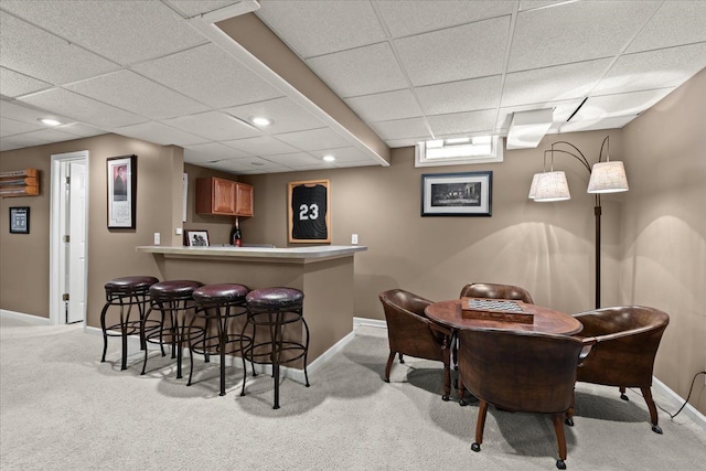 bar with light carpet, recessed lighting, baseboards, a paneled ceiling, and indoor bar