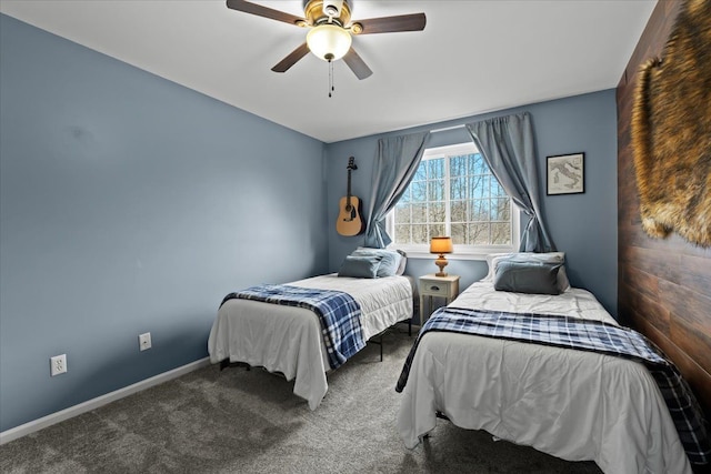 carpeted bedroom featuring baseboards and a ceiling fan