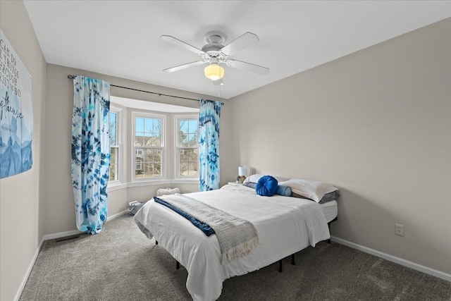 carpeted bedroom featuring a ceiling fan and baseboards