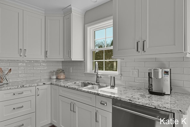 kitchen with a sink, tasteful backsplash, dishwasher, and white cabinets