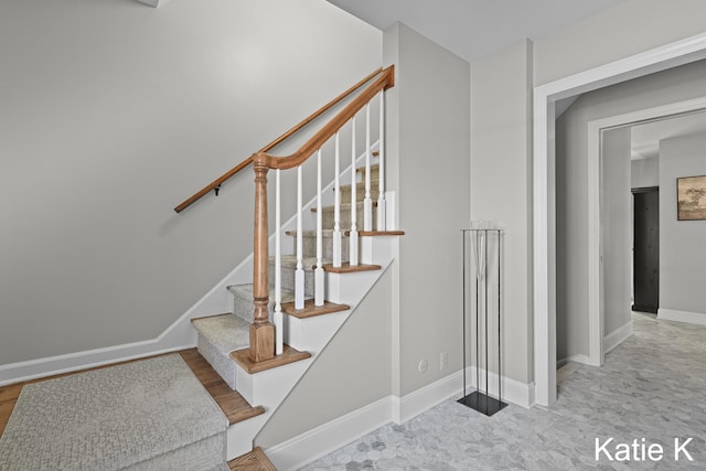 staircase featuring baseboards