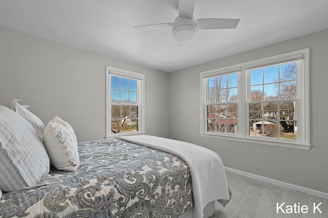 carpeted bedroom with baseboards and ceiling fan