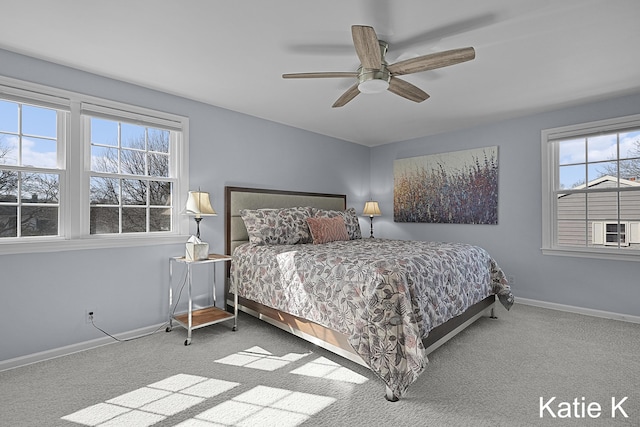 carpeted bedroom with baseboards and a ceiling fan