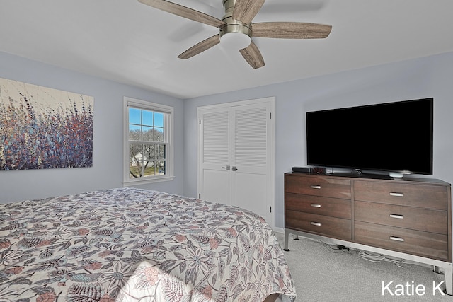 carpeted bedroom with a closet and ceiling fan