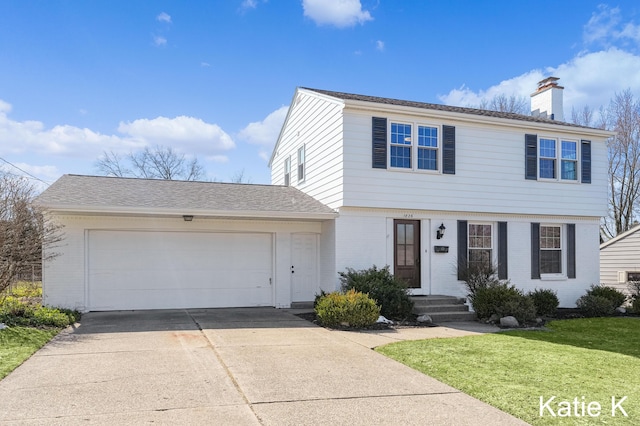 colonial house with a front lawn, concrete driveway, a garage, brick siding, and a chimney