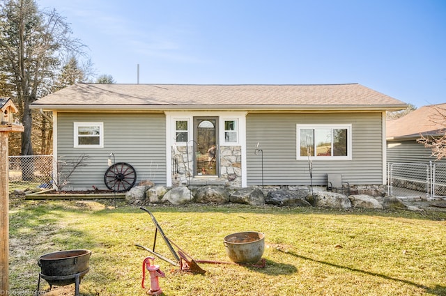 view of front of home with a front yard and fence