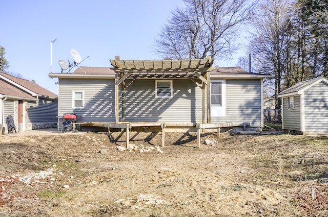 back of property with an outbuilding and a pergola