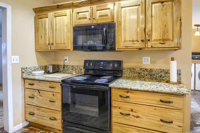 kitchen featuring baseboards, light stone countertops, black appliances, and washer / clothes dryer