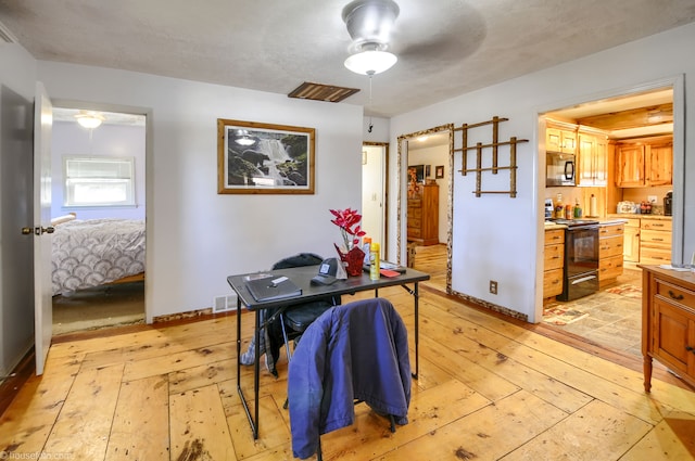 dining room with visible vents, baseboards, light wood-style floors, and a ceiling fan