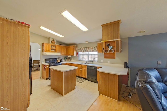 kitchen with black appliances, under cabinet range hood, a kitchen island, open floor plan, and vaulted ceiling