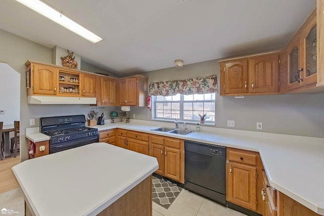 kitchen featuring black appliances, light countertops, under cabinet range hood, and a sink