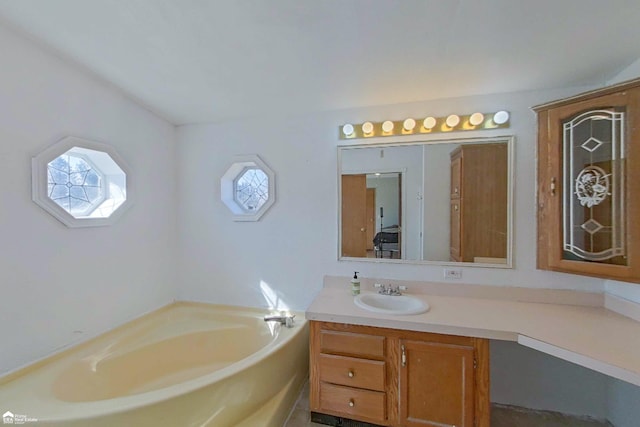 full bath with vanity and a garden tub