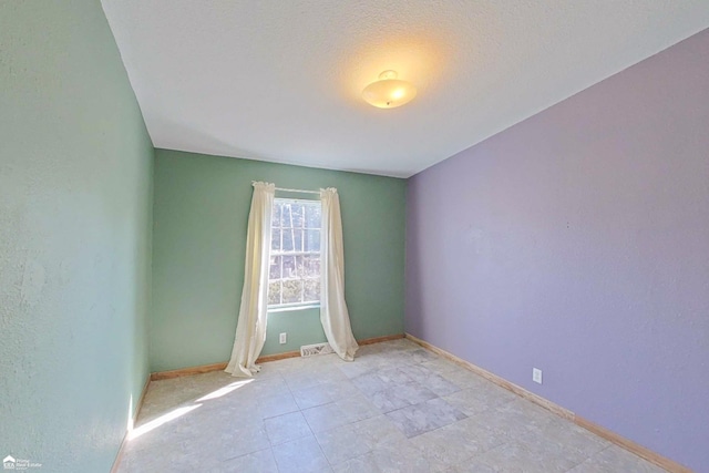 unfurnished room featuring baseboards