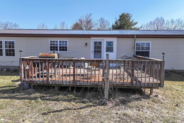 rear view of house featuring a deck and metal roof