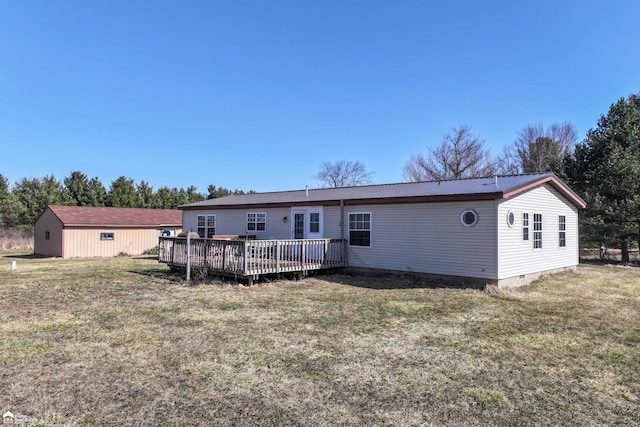 back of house featuring crawl space, metal roof, a lawn, and a deck