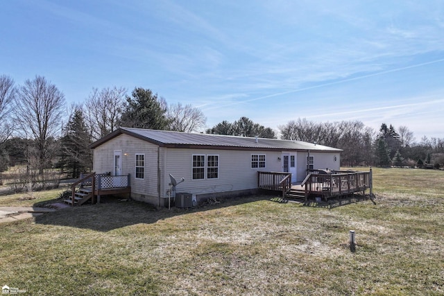 manufactured / mobile home featuring crawl space, central air condition unit, metal roof, and a front yard