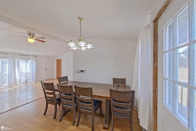 dining area with ceiling fan with notable chandelier and light wood-style floors