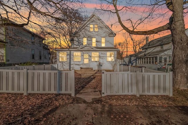 back of house with a fenced front yard