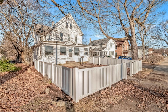 back of property featuring a fenced front yard