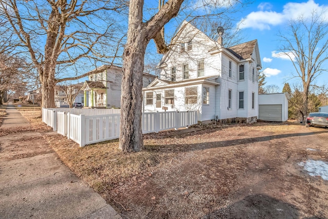 view of side of home with a fenced front yard