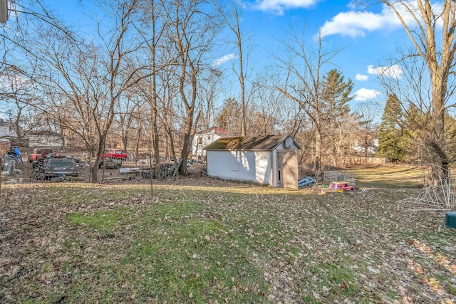 view of yard with a storage unit and an outbuilding