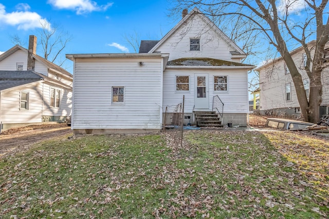 back of house featuring a yard and entry steps